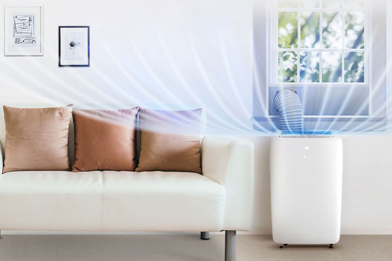 LG portable air conditioner in a living room next to a couch