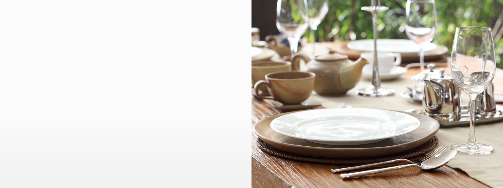 A sparkling table with sanitized dishes and glasses.